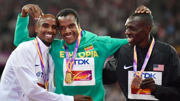 Ethiopia's Muktar Edris (centre) celebrates 5000-metre gold with silver medalist Mo Farah, left, and bronze medalist Paul Kipkemoi Chelimo