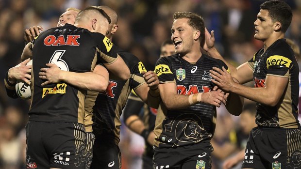 Leapfrog into sixth spot: Peter Wallace celebrates scoring a try with Panthers teammates.
