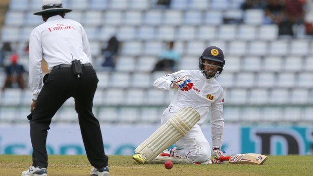 Sri Lanka's Dhananjaya de Silva slips while running between wickets.