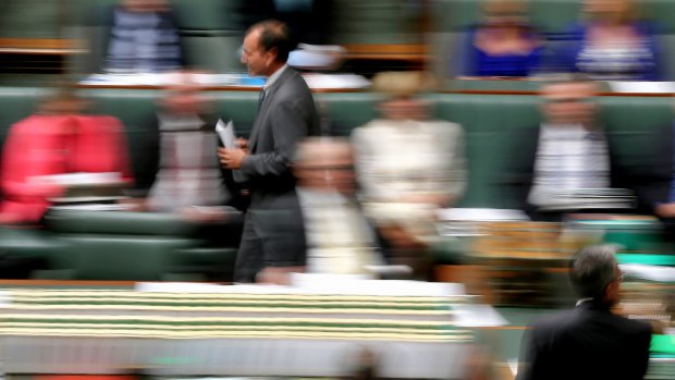 Mal Brough returns to his seat after responding to a question during question time.