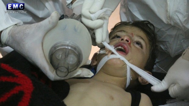 Syrian doctors treat a child following a suspected chemical attack in Syria on April 4, 2017.
