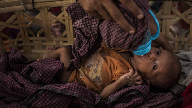 A Rohingya woman feeds her one-month-old baby at an internal displacement camp in Sittwe, Myanmar.