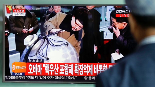 A South Korean man watches a TV news program showing North Korean leader Kim Jong-un inspecting military installations.
