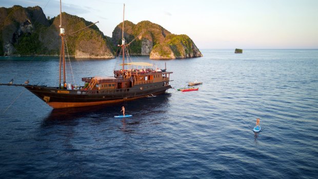 Sunset stand-up paddle boarding around the liveaboard boat.