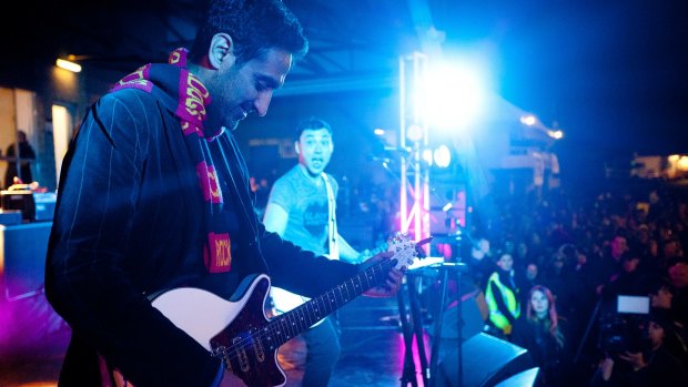 Rocking out for charity ... Waleed Aly performed a soaring guitar solo with Regurgitator at the Reclink Community Cup in Elsternwick in Melbourne.