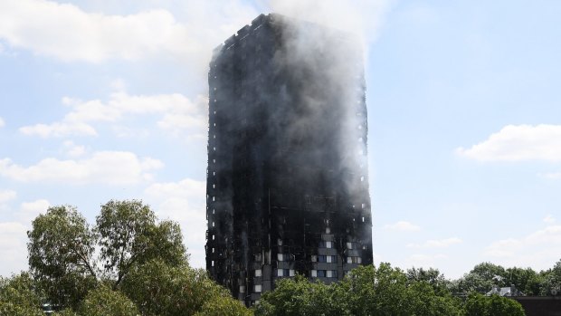 Smoke continues to rise from the burning 24-storey Grenfell Tower block in Latimer Road, west London.
