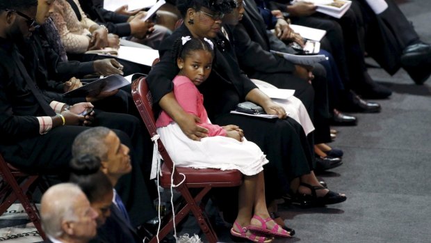 Malana Pinckney, daughter of Reverand Clementa Pinckney, is hugged by her mother Jennifer at the start of her father's funeral  at the Emanuel African Methodist Episcopal Church in Charleston, South Carolina.