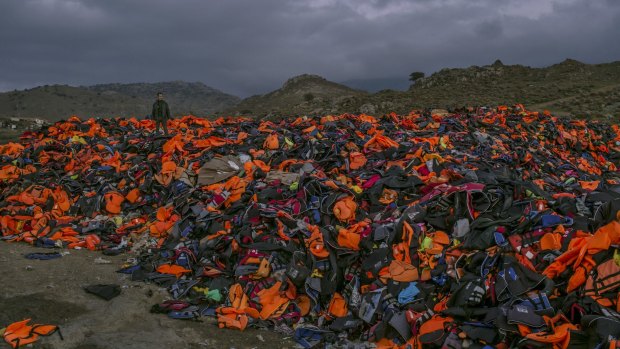 A pile of discarded life vests, inner tubes and deflated rubber dinghies used by migrants who made the water crossing from Turkey, on Lesbos island in Greece, earlier this month. 