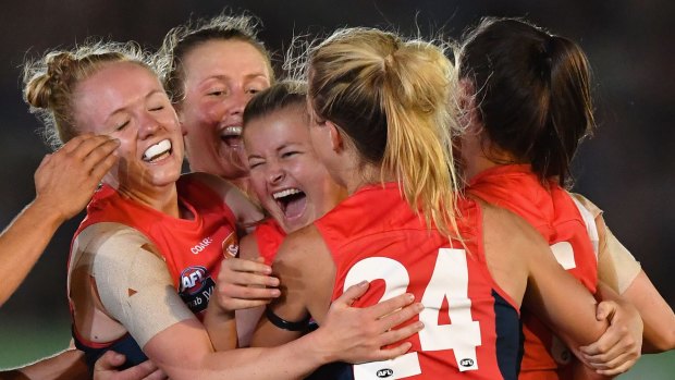 Melbourne celebrate their first ever win in the AFLW on Saturday night.