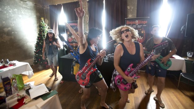Staff from WPC play air guitar during the competition to find the best male and female bogan during Bogan Bingo at the Leveson Hotel in North Melbourne.