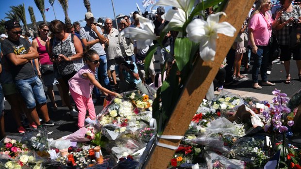 People visit the scene and lay tributes to the victims of a terror attack on the Promenade des Anglais in Nice, France.