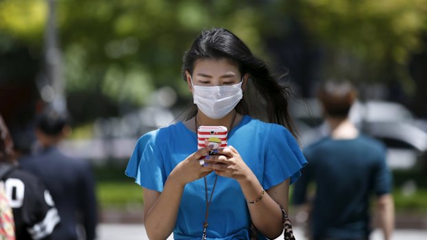 A woman wearing masks to prevent contracting MERS at Myeongdong shopping district in central Seoul, South Korea on Wednesday.