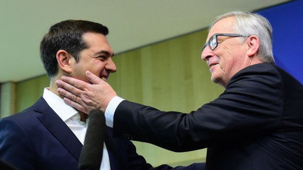 Greece's Prime Minister Alexis Tsipras (left) is welcomed by European Commission President Jean-Claude Juncker ahead of an emergency leader's summit in Brussels.