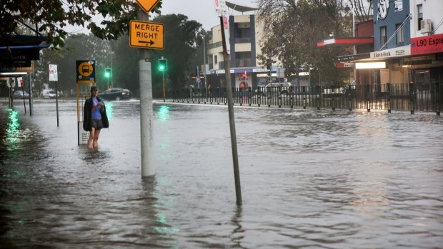 Waters rise flooding homes and shops on Pittwater Road, Narrabeen.