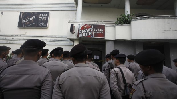 Indonesian police outside a 'cafe' in Kalijodo.