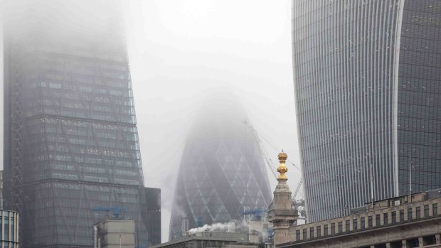The London skyscraper known as "the Gherkin" stands shrouded in smog as heavy pollution descends on the city.