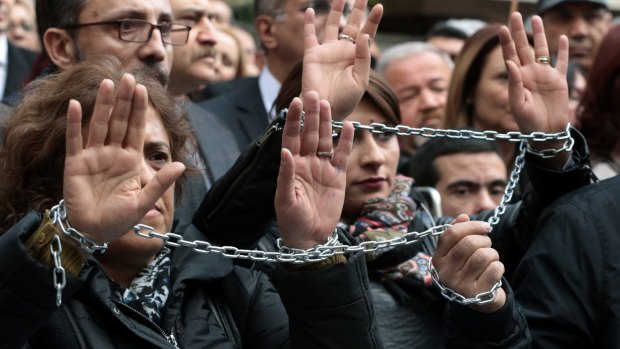 Journalists with chained hands protest in Ankara amid deepening concerns over media freedoms in Turkey.