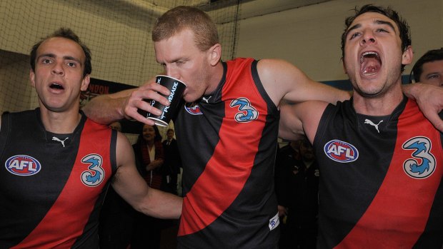 Adam Ramanauskas, left, with Dustin Fletcher and Jobe Watson, after his footy comeback.
