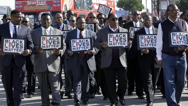 Birthday message: Members of the group Suits in Solidarity march at the annual Kingdom Day Parade in Los Angeles, in honour of Martin Luther King.
