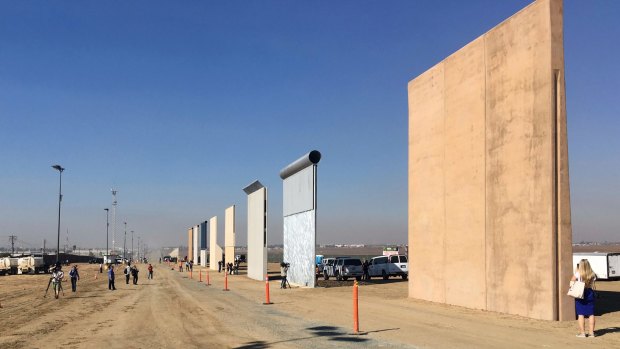 People look at prototypes of a border wall in San Diego in October. 