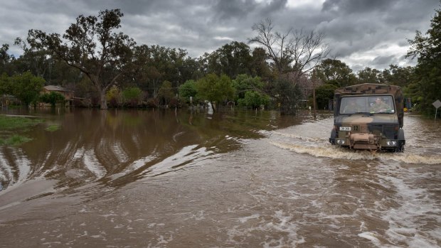 An Australian Army Unimog truck from 5th Brigade moves through inundated roads during flood relief operations in Forbes.