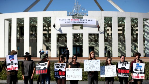 Protestors on the forecourt of Parliament House in Canberra on Thursday. 