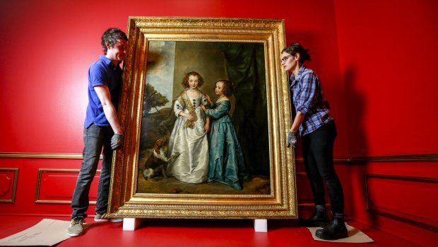 NGV staff Justin Audrins and Emma Salaoras work on the portrait of Philadelphia and Elizabeth Wharton by Anthony van Dyck.