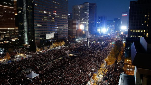 Thousands of South Koreans take to the streets in the city centre to demand President Park Geun-Hye to step down.