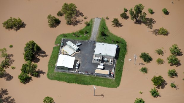 Before the peak:  A property is surrounded by floodwaters near Rockhampton in the aftermath of Cyclone Debbie.