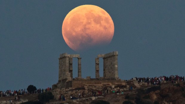 A full moon rises above the 5th Century B.C. Temple of Poseidon at Cape Sounio, south of Athens.