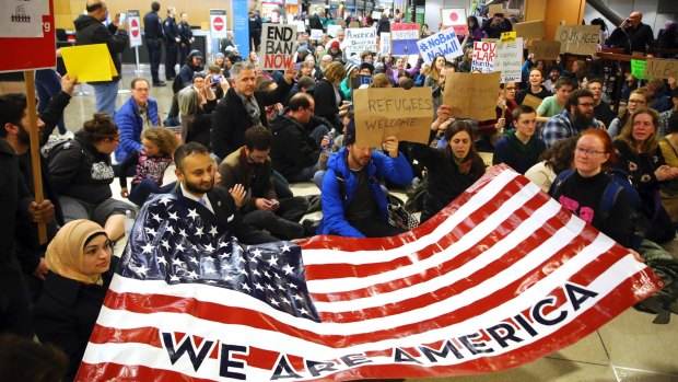 Donald Trump's edict restricting immigration to the US has drawn plenty of opposition, including this sit-down demonstration at Seattle-Tacoma International Airport.