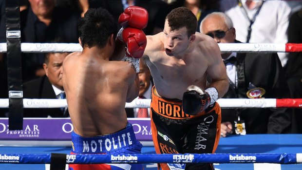 Man v mountain: Manny Pacquiao and Jeff Horn trade blows. 