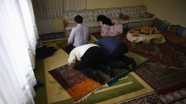 Uighur refugee men pray in a gated complex in the central city of Kayseri, Turkey, earlier this year. 