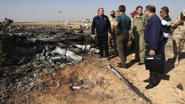 Russian Emergency Situations Minister Vladimir Puchkov, left, talks with Russian Transport Minister Maxim Sokolov, fifth right, as they inspect the wreckage of a passenger jet bound for St. Petersburg that crashed in Egypt.