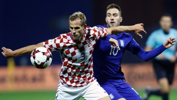 Greece's Kostas Fortounis fights for the ball with Croatia's Ivan Strinic.
