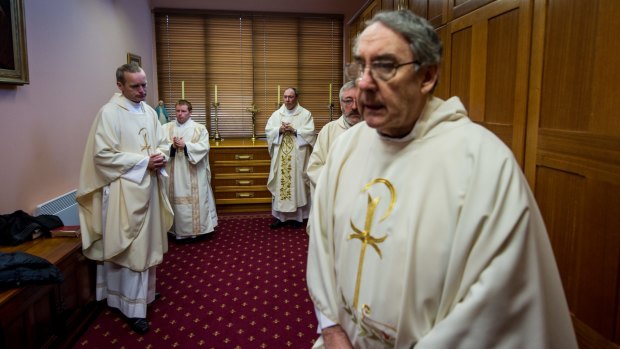 Corpus Christi College priests prepare for the morning mass.