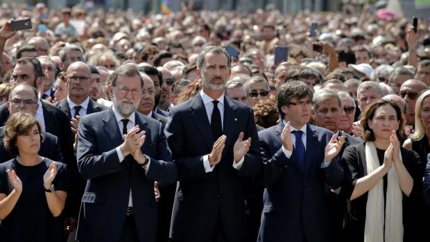 A minute's silence is followed by applause in Barcelona on Friday. Pictured centre are Prime Minister Mariano Rajoy, King Felipe of Spain, and Catalonia's regional president Carles Puigdemont.