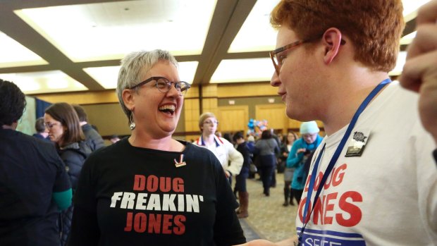 Supporters Frannie James talks with Connor Welch during an election-night watch party for Democratic candidate Doug Jones on Tuesday. 