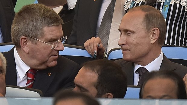 At odds: IOC President Thomas Bach with Russian President Vladimir Putin before the World Cup final in Rio in July.