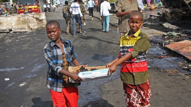 Somali children assist  security forces in the rescue efforts in Mogadishu.