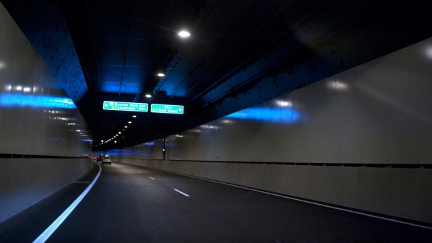 Police say an ambulance officer was assaulted in the vehicle which had been forced to stop in Brisbane's AirportLink tunnel.