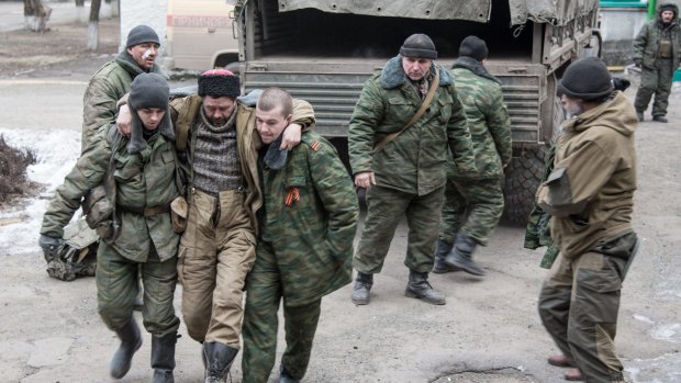 A wounded pro-Russian separatist is helped into a hospital in Stakhanov, near Debaltseve.