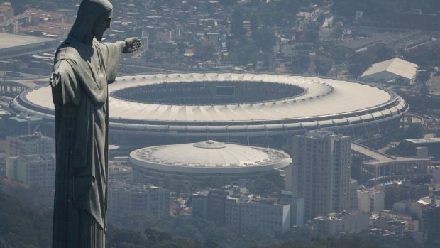 Iconic setting: The Christ the Redeemer statue stands above Maracana stadium in Rio de Janeiro.