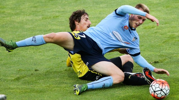 Brought down: Andrew Hoole of Sydney FC, here tackled by Phoenix's Albert Riera, also failed to convert a crucial penalty.