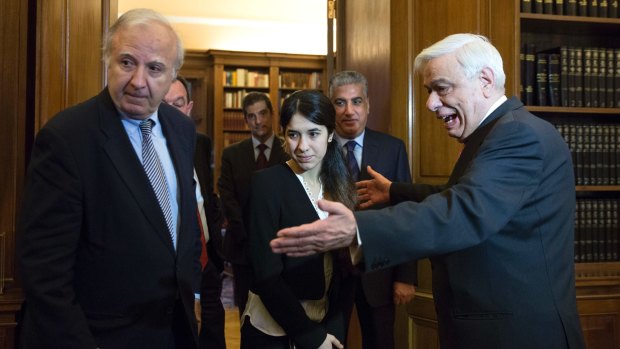 Nadia Murad, centre, is welcomed by Greek President Prokopis Pavlopoulos, right, before their meeting in Athens last year.