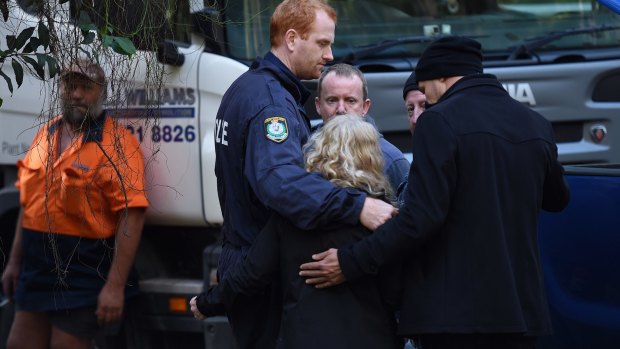 NSW Detectives embrace Matthew Leveson's parents Mark and Faye after locating the possible burial place of their son.