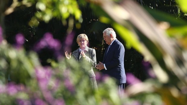 Rex Tillerson meets and Julie Bishop walk on the grounds of Government House in Sydney on Monday.