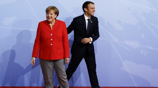 German Chancellor Angela Merkel and French President Emmanuel Macron upon his arrival at the G20.