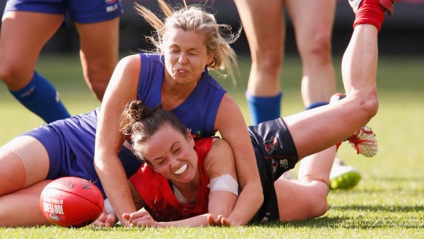 Pearce is tackled during a Women's AFL exhibition match in May. 