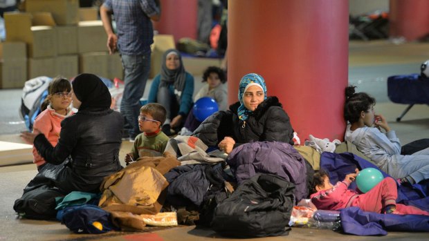 Refugees rest in a parking garage in the main rail station in Salzburg, Austria,  in September 2015.